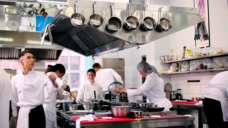 Chefs at work in a busy restaurant kitchen