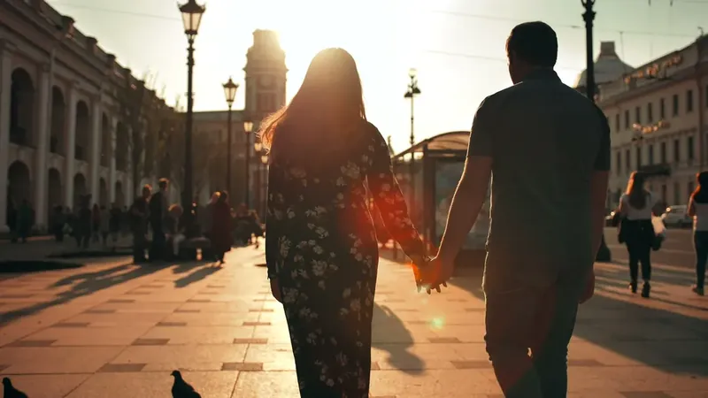 A couple walking hand in hand at sunset