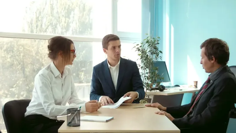 A couple meeting a lawyer across a desk